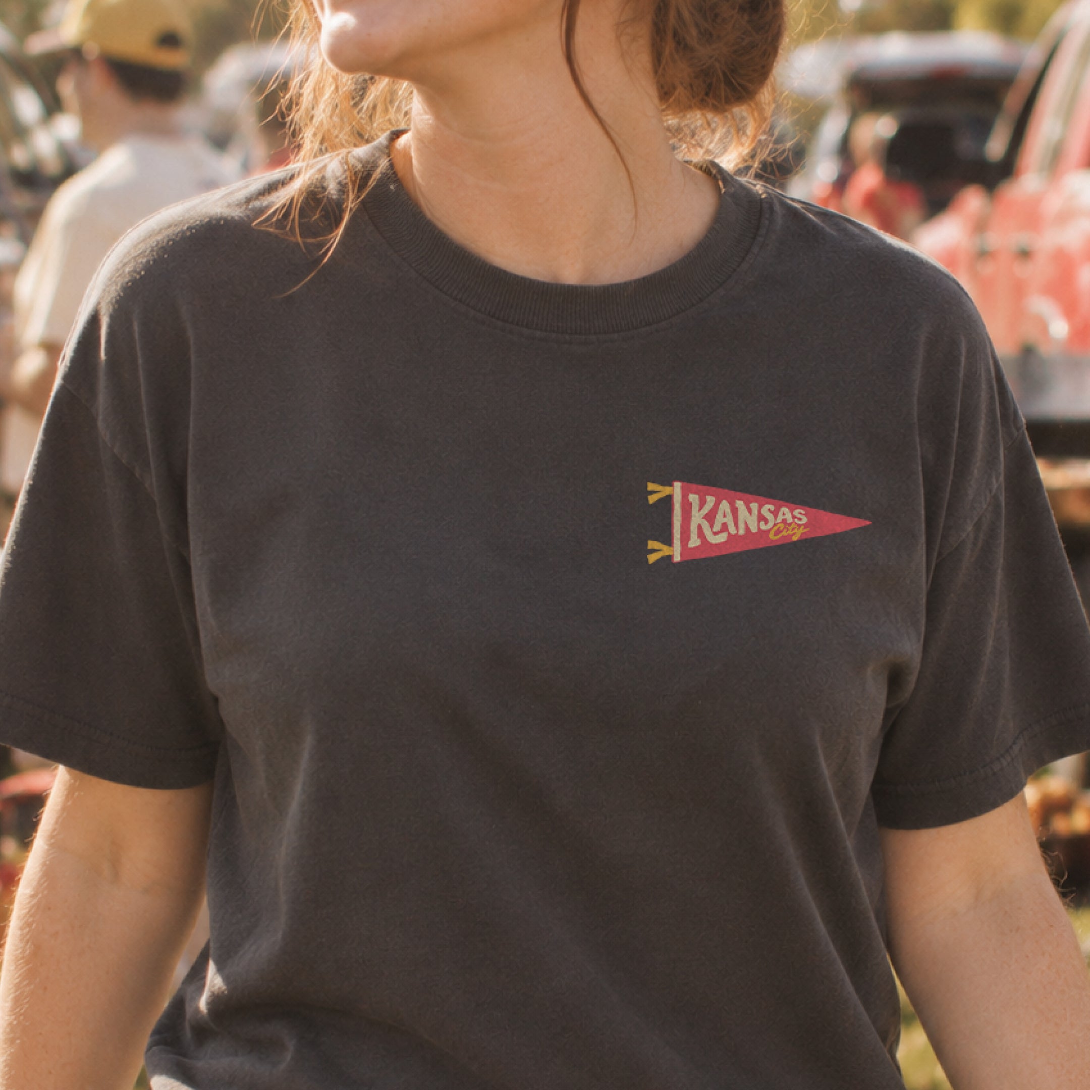 ’Tis the Damn Season Kansas City Stadium Tee in Graphite, front, on model