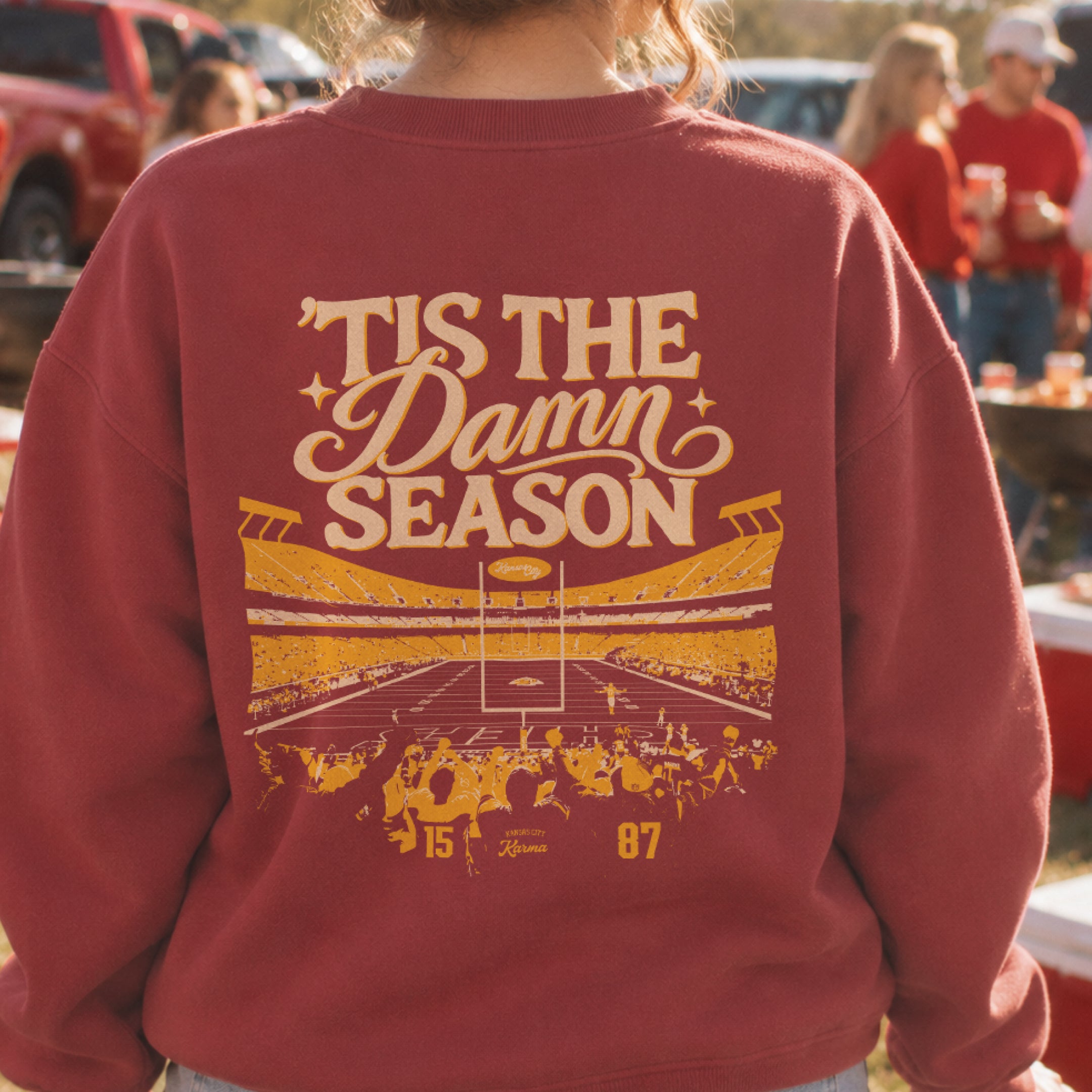 ’Tis the Damn Season Kansas City Stadium Crewneck in Crimson, back, on model