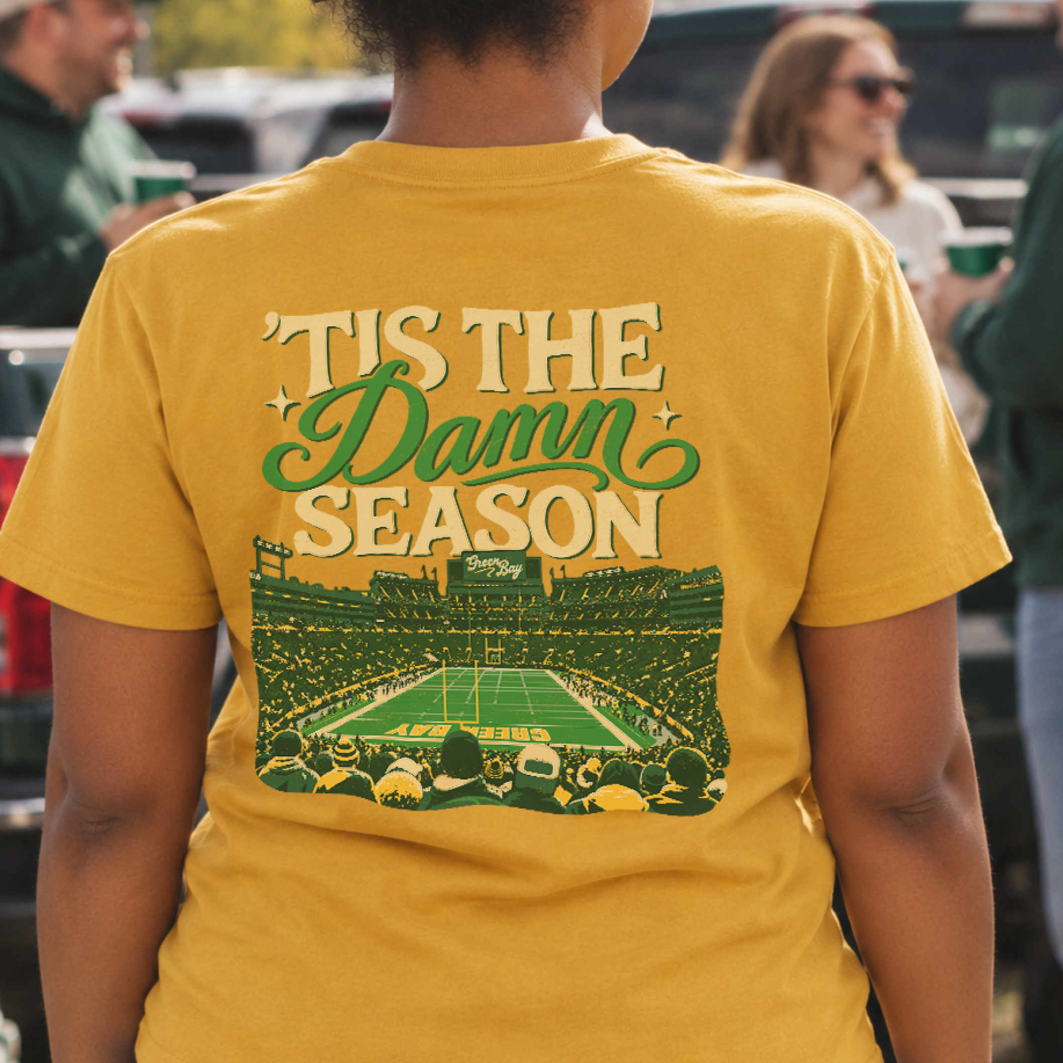’Tis the Damn Season Green Bay Tee in Mustard, on model, back