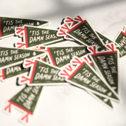 Pile of 'Tis the Damn Season pennant stickers